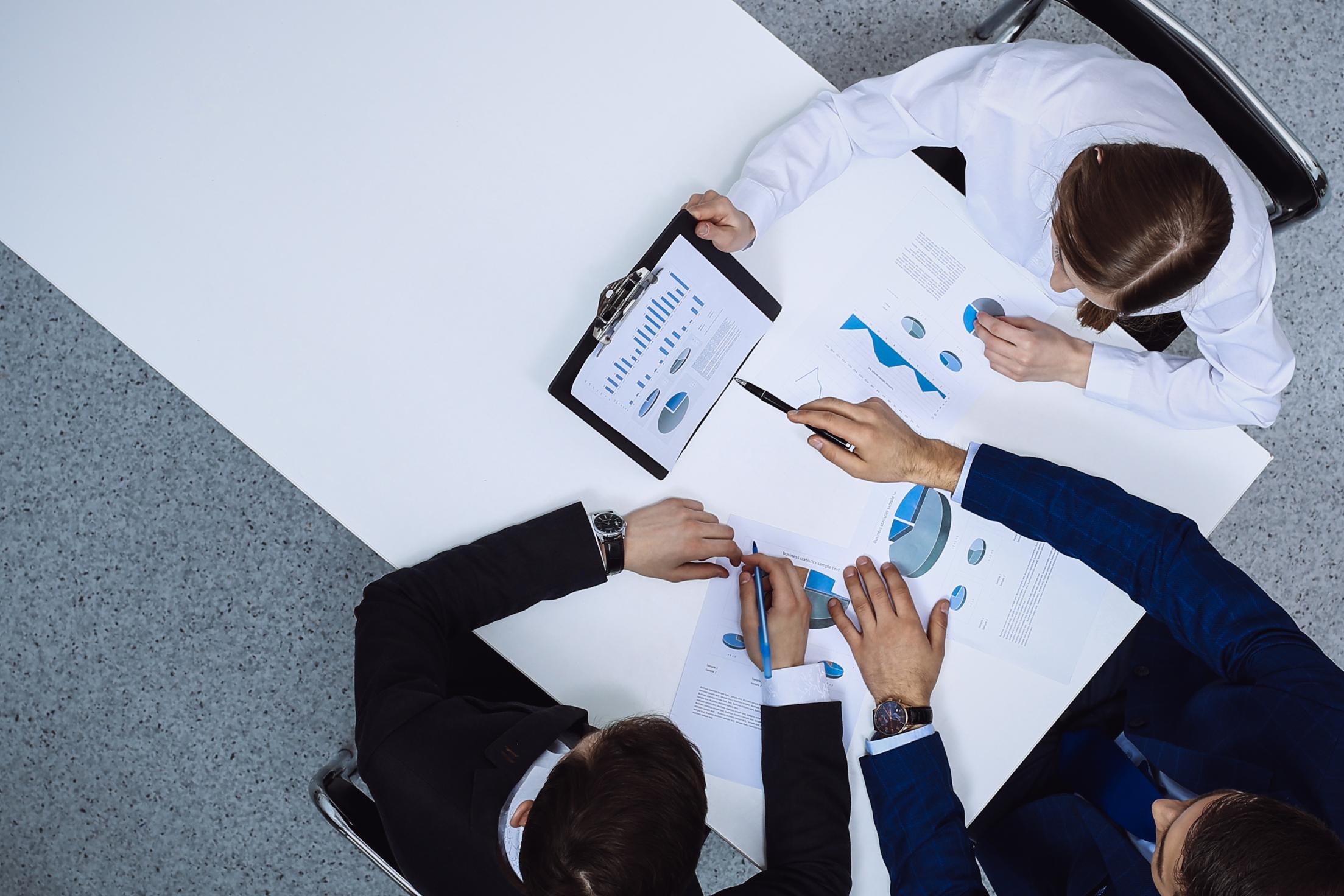 Investors reviewing financial documents during a UAE private market deal evaluation